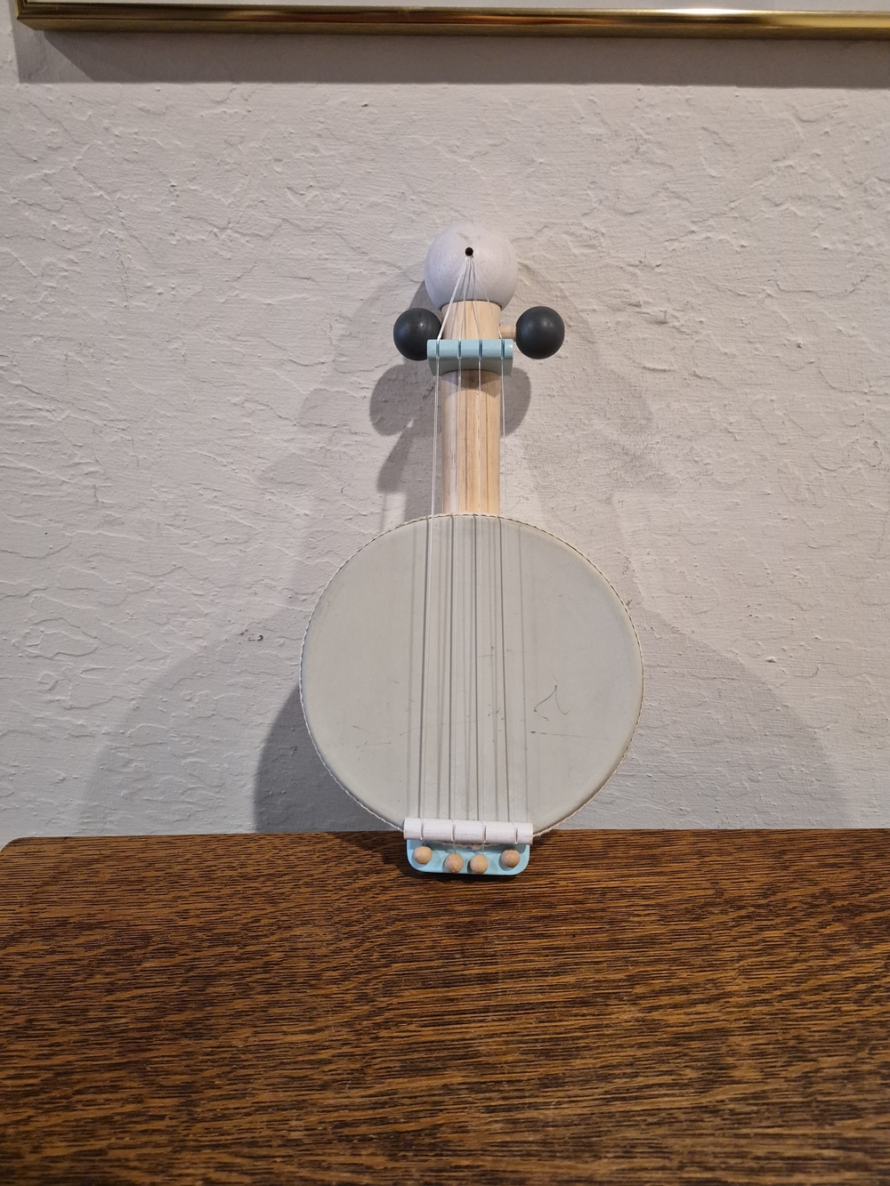 Plan Toys x PBK Kids Banjo in a cream and blue-gray colorway